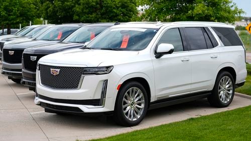 FILE - Unsold 2024 Escalade utility vehicles sit in a row outside a Cadillac dealership on June 2, 2024, in Lone Tree, Colo. General Motors reports earnings on Tuesday, July 23, 2024. (AP Photo/David Zalubowski, File)