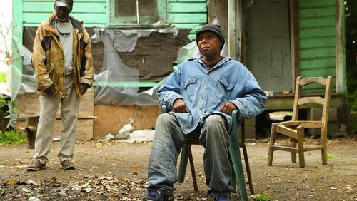 **** POSSIBLE VISUAL LEDE**** 032915 PELHAM: Poverty stricken Adel Edwards, 54, sits outside his home by a small pile of leaves with his friend Henry Smith, 62, who is often with him on Monday, March 30, 2015, in Pelham. Edwards was fined $500 by a judge for burning without a permit and was placed on 12 months of probation with a private probation company. Curtis Compton / ccompton@ajc.com