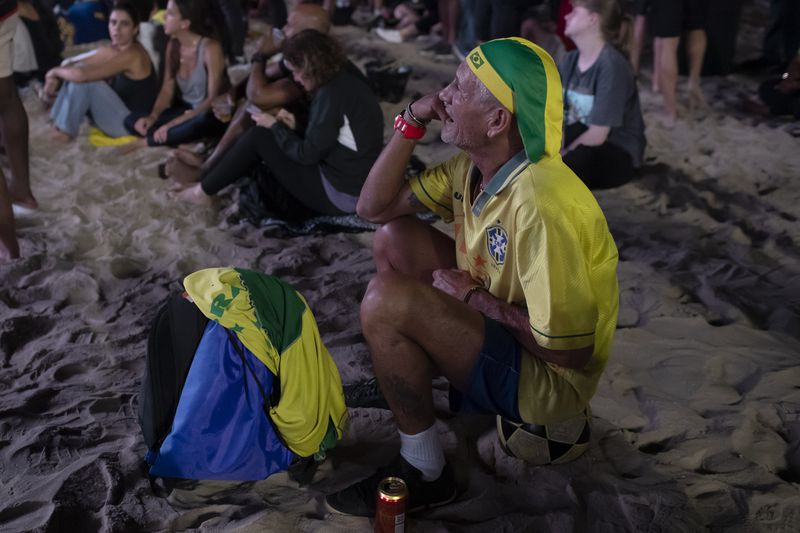 A Brazil fan watches his team's Copa America Group D soccer match against Colombia on a screen for fans on Copacabana beach in Rio de Janeiro, Tuesday, July 2, 2024. (AP Photo/Bruna Prado)