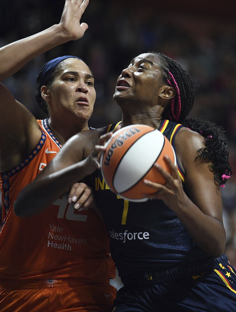 Indiana Fever's Aliyah Boston (7) attempts to move past Connecticut Sun's Brionna Jones (42) during a first-round WNBA basketball playoff game at Mohegan Sun Arena, Sunday, Sept. 22, 2024. (Sarah Gordon/The Day via AP)