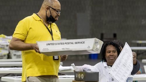 06/10/2020 - Atlanta, Georgia - Fulton County employees continue to count mail-in ballots the day after the Georgia primary election at the Georgia World Congress Center in Atlanta, Wednesday, June 10, 2020. A spokesperson for Fulton County said that they will announce the final number of mail-in ballots on Wednesday. (ALYSSA POINTER / ALYSSA.POINTER@AJC.COM)