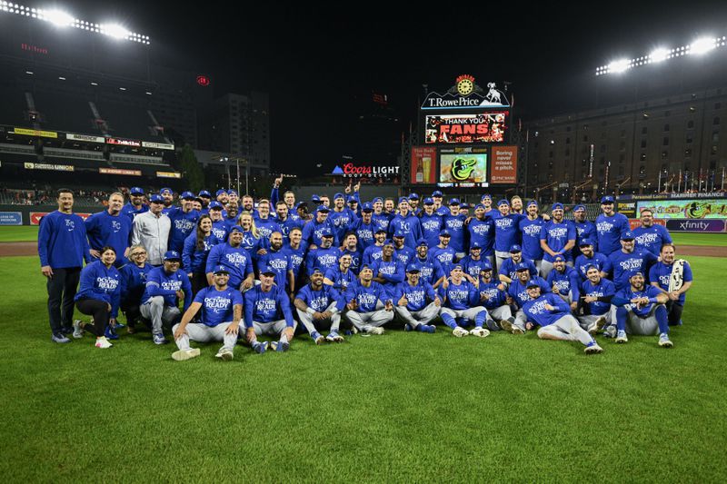 Kansas City Royals players and staff pose for photographers after defeating the Baltimore Orioles 2-1 in Game 2 of an AL Wild Card Series baseball game, Wednesday, Oct. 2, 2024 in Baltimore. (AP Photo/Nick Wass)