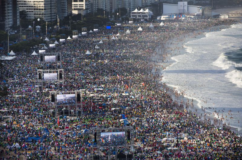 FILE - Pilgrims and residents gather on Copacabana beach before the arrival of Pope Francis for World Youth Day in Rio de Janeiro, Brazil, on July 27, 2013. (AP Photo/Felipe Dana, File)