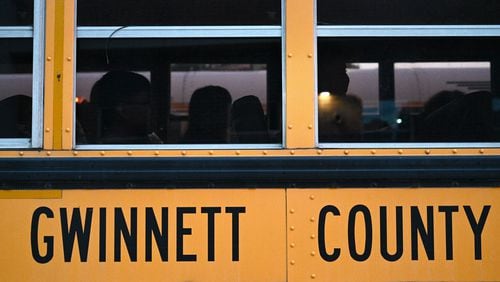 Students wait in the bus as they arrive for the first day of school at Seckinger High School in Buford on Wednesday, August 3, 2022. Gwinnett expects a revenue hit due to a newly expanded homestead exemption. (Hyosub Shin / Hyosub.Shin@ajc.com)