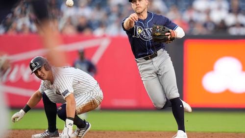 Tampa Bay Rays' Taylor Walls throws out New York Yankees' DJ LeMahieu at first base after forcing out New York Yankees' Anthony Volpe, left, during the second inning of a baseball game, Friday, July 19, 2024, in New York. (AP Photo/Frank Franklin II)