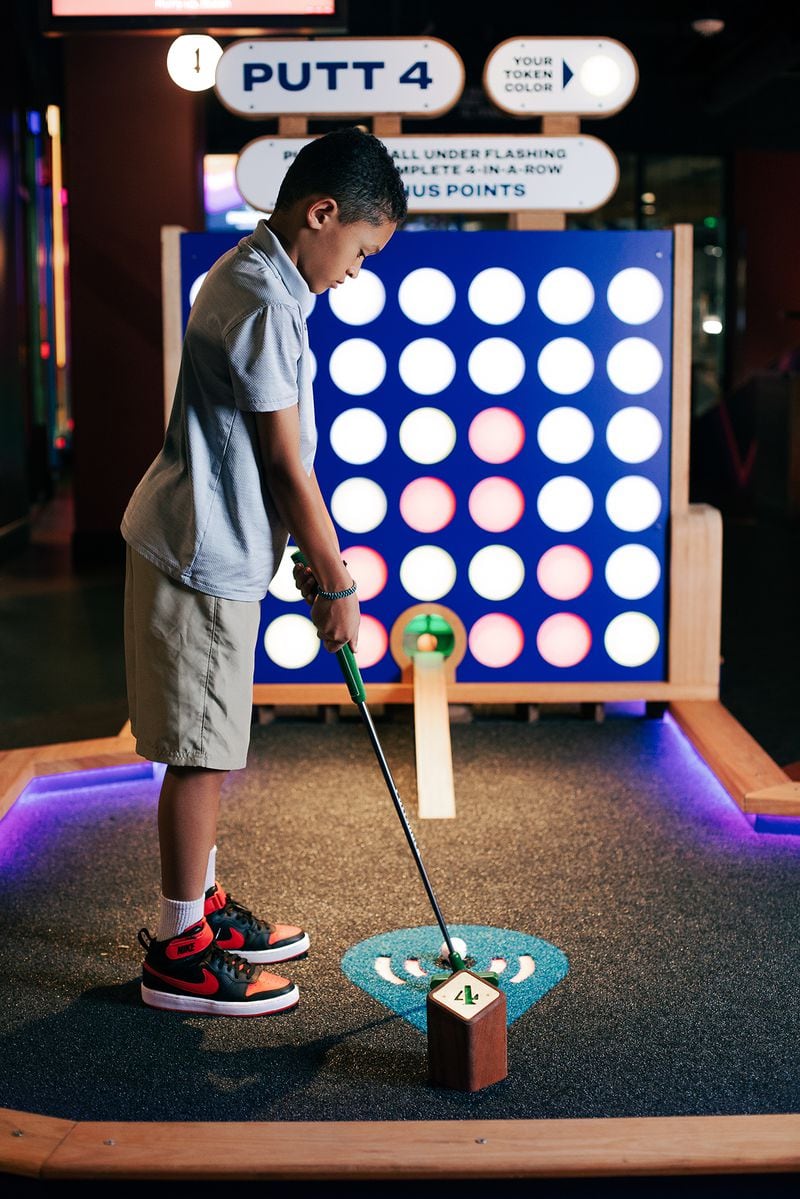 At Puttshack -- Atlanta, a youngster makes sure he’s set for the swing. 
(Courtesy of Puttshack)
