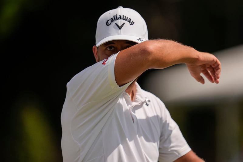 Xander Schauffele wipes sweat on the seventh green during the second round of the Tour Championship golf tournament, Friday, Aug. 30, 2024, in Atlanta. (AP Photo/Mike Stewart)