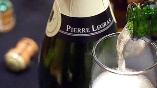 Pouring a glass of Pierre Legras Champagne Grande Cru Brut Blanc de Blancs at West Point Market in Akron, Ohio, on December 15, 2017. (Phil Masturzo/Akron Beacon Journal/TNS)