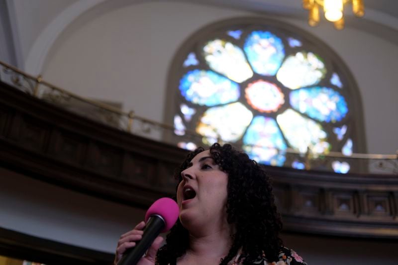 Debora Marcano, a member of Iglesia Jesucristo es el Rey (Church Jesus Christ is the King) sings during a service in Reading, Pa., on Sunday, June 9, 2024. The thriving Latino congregation has shared the building with First Baptist Church for nearly a decade. In a sign of Reading's changing demographics, the aging and shrinking congregation of white Protestants recently donated the building to Iglesia Jesucristo es el Rey. (AP Photo/Luis Andres Henao)