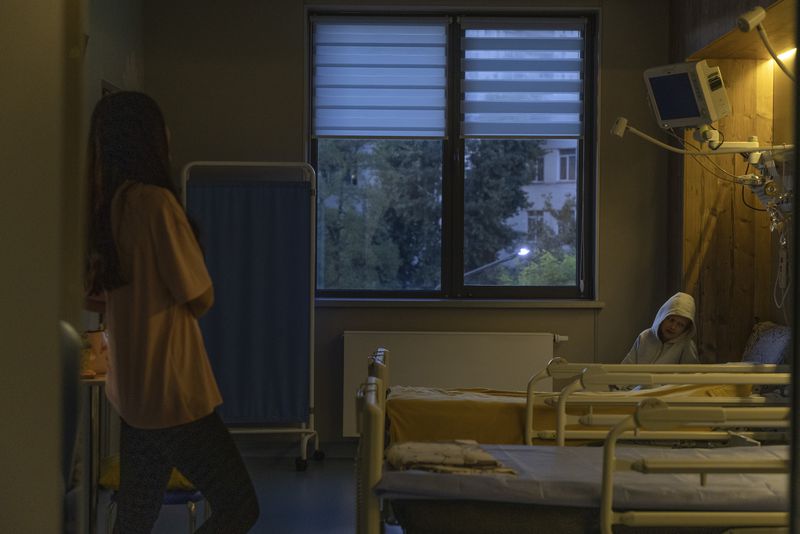 Kira Vertetska, 8 and her mother Daria inside their room at Okhmatdyt children's hospital in Kyiv, Ukraine, Thursday Sept. 19, 2024. (AP Photo/Anton Shtuka)