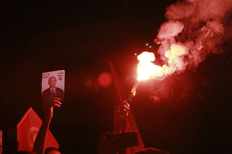 Supporters of Tunisian president and candidate for re-election Kais Saied celebrate after the announcement of the provisional results for the presidential elections, in the capital Tunis, Tunisia, Sunday, Oct. 6, 2024. (AP Photo/Anis Mili)