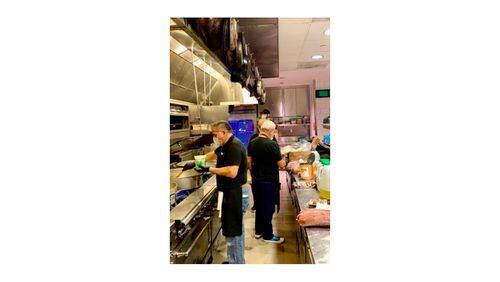 True Story Brands employees cook meals in the kitchen of Biltong Bar for the Frontline Dine initiative serving hospital  personnel at Children's Healthcare of Atlanta. COURTESY OF TRUE STORY BRANDS