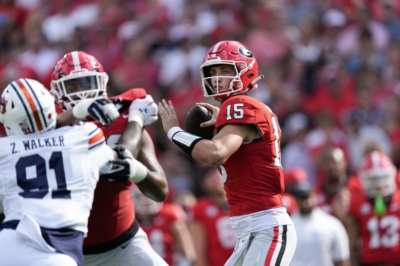 Georgia quarterback Carson Beck (15) throws from the pocket in the first half of an NCAA college football game against Auburn Saturday, Oct. 5, 2024, in Athens, Ga. (AP Photo/John Bazemore)