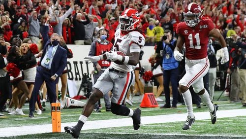 Georgia defensive back Kelee Ringo intercepts Alabama and returns it for a touchdown for a 33-18 lead and victory over Alabama in the College Football Playoff championship game on Monday, Jan. 10, 2022, in Indianapolis. (AJC 2022)