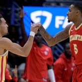 Atlanta Hawks guard Trae Young (11) celebrates a score by guard Dejounte Murray (5) during the second half of an NBA basketball game against the New Orleans Pelicans in New Orleans, Saturday, Nov. 4, 2023. (AP Photo/Matthew Hinton)