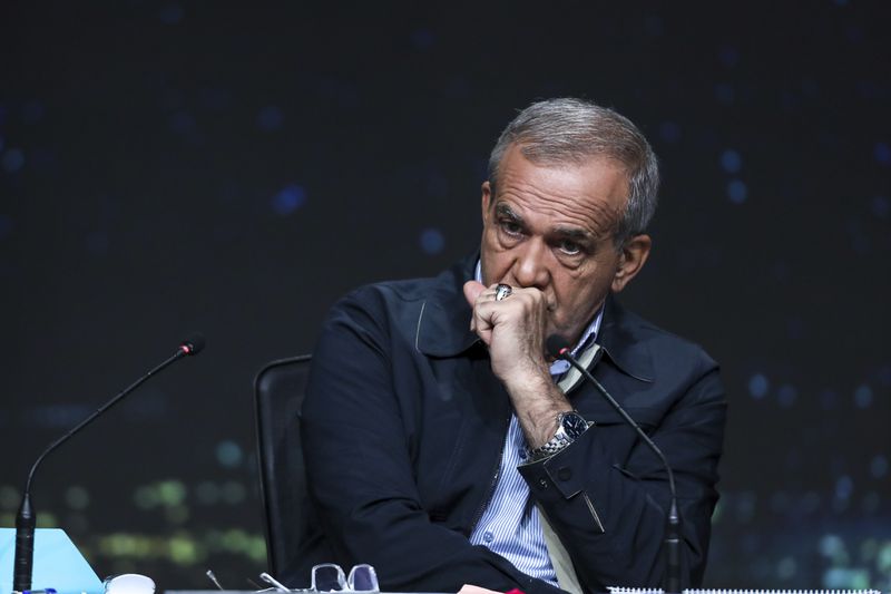 In this picture made available by Iranian state-run TV, IRIB, reformist presidential candidate for June 28, election Masoud Pezeshkian sits in a debate of the candidates at the TV studio in Tehran, Iran, Thursday, June 20, 2024. (Morteza Fakhri Nezhad/IRIB via AP)