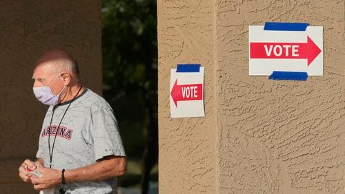 A precinct worker walks outside a voting location during the state's primary election, Tuesday, July 30, 2024, in Sun City West, Ariz. (AP Photo/Ross D. Franklin)