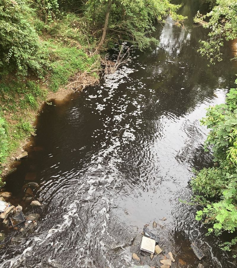 A photo of the South River near Forrest Park Road shows black water flowing on Sept. 6, 2024. State environmental officials have confirmed that they are investigating the pollution incident, which local water advocates say caused a fish kill.