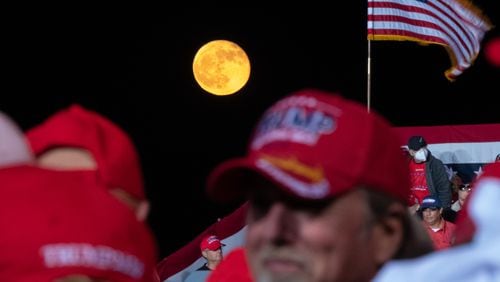 The moon rises behind supporters before the beginning of a President Donald Trump rally at Richard B. Russell Airport in Rome on Sunday evening, Nov. 1, 2020. A rally for his rival, Joe Biden, was canceled in Rome because Democrats said there was a threat from a militia presence. (Photo: Ben Gray for The Atlanta Journal-Constitution)