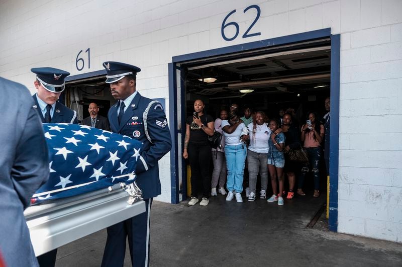 Chantimekki Fortson and daughter Harmoni Fortson watches as a United States Air Force Honor Guard loads the transfer case of SRA Roger Fortson into a hearse at the Hartsfield-Jackson Airport in Atlanta, GA on May 16, 2024. Fortson was killed by a Florida sheriff deputy on May 3 after answering his door while holding a gun. (Photo by Michael A. McCoy)
