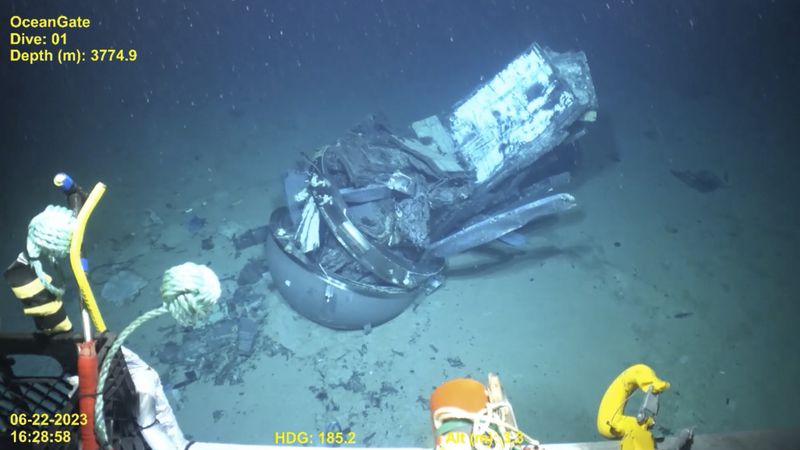 This June 2023 United States Coast Guard still frame from video provided by Pelagic Research Services, shows remains of the Titan submersible, center, on the floor of the Atlantic Ocean. (U.S. Coast Guard Video courtesy Pelagic Research Services via AP)