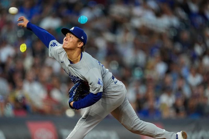 Los Angeles Dodgers starting pitcher Yoshinobu Yamamoto works against the Colorado Rockies in the second inning of a baseball game, Saturday, Sept. 28, 2024, in Denver. (AP Photo/David Zalubowski)