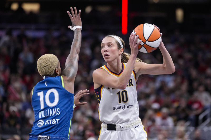 Indiana Fever guard Lexie Hull (10) looks to pass over Minnesota Lynx guard Courtney Williams (10) in the second half of a WNBA basketball game in Indianapolis, Friday, Sept. 6, 2024. (AP Photo/Michael Conroy)