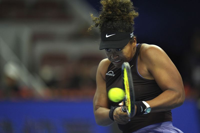 Naomi Osaka of Japan returns a shot from Coco Gauff of the United States in a women's singles match for the China Open tennis tournament held at the National Tennis Center in Beijing, Tuesday, Oct. 1, 2024. (AP Photo/Ng Han Guan)