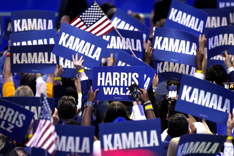 Supporters of Vice President Kamala Harris held signs at the Democratic National Convention earlier this month.