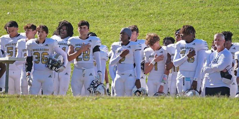 Apalachee players say the pledge before the game. The high school team returned to the field against Clarke Central on Saturday, Sept. 28, 2024. It was Apalachee High's first game since the mass shooting at Apalachee in Georgia on Sept. 4.

 Nell Carroll for The Atlanta Journal-Constitution