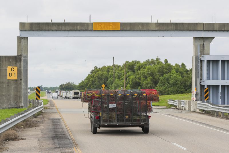 Crabbers move their traps to inside the levy protection system ahead of Tropical Storm Francine, Monday, Sept. 9, 2024, in lower St. Bernard Parish, La. (David Grunfeld/The New Orleans Advocate via AP)