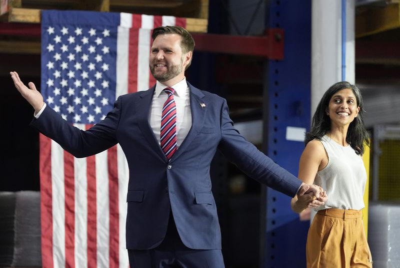 FILE - Republican vice presidential nominee Sen. JD Vance, R-Ohio, left, and his wife Usha Vance arrive at a campaign event, Aug. 28, 2024, in DePere, Wis. (AP Photo/Morry Gash, File)