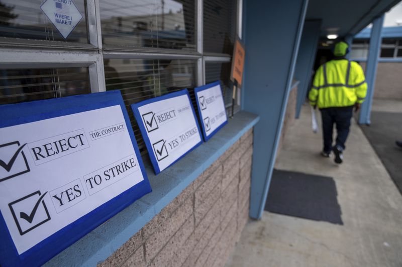 Signs encouraging International Aerospace Machinists union members to vote no on a contract offer with airplane maker Boeing, are pictured at the union's hall, on Thursday, Sept. 12, 2024, in Renton, Wash. (AP Photo/Stephen Brashear)