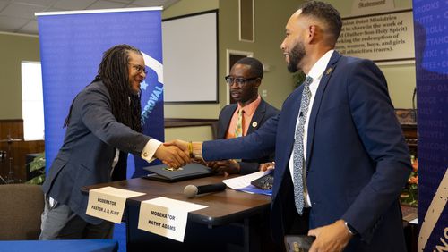 Ralph Long III, left, and RaShaun Kemp, who are facing off in a Democratic primary runoff for the state Senate on June 18, shake hands following a candidates forum earlier this week. (Ben Gray / Ben@BenGray.com)