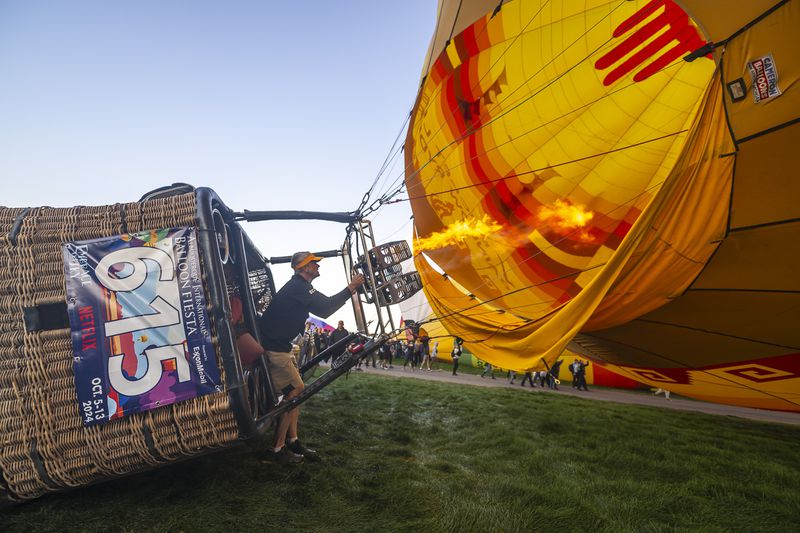 Pilot Brad Rice of Rio Rancho, N.M., prepares to take off in his balloon during the mass ascension at the 52nd Albuquerque International Fiesta in Albuquerque, N.M., on Saturday, Oct. 5, 2024. (AP Photo/Roberto E. Rosales)