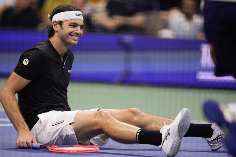 Taylor Fritz, of the United States, reacts after falling on the court in the first set against Frances Tiafoe, of the United States, during the men's singles semifinal of the U.S. Open tennis championships, Friday, Sept. 6, 2024, in New York. (AP Photo/Frank Franklin II)