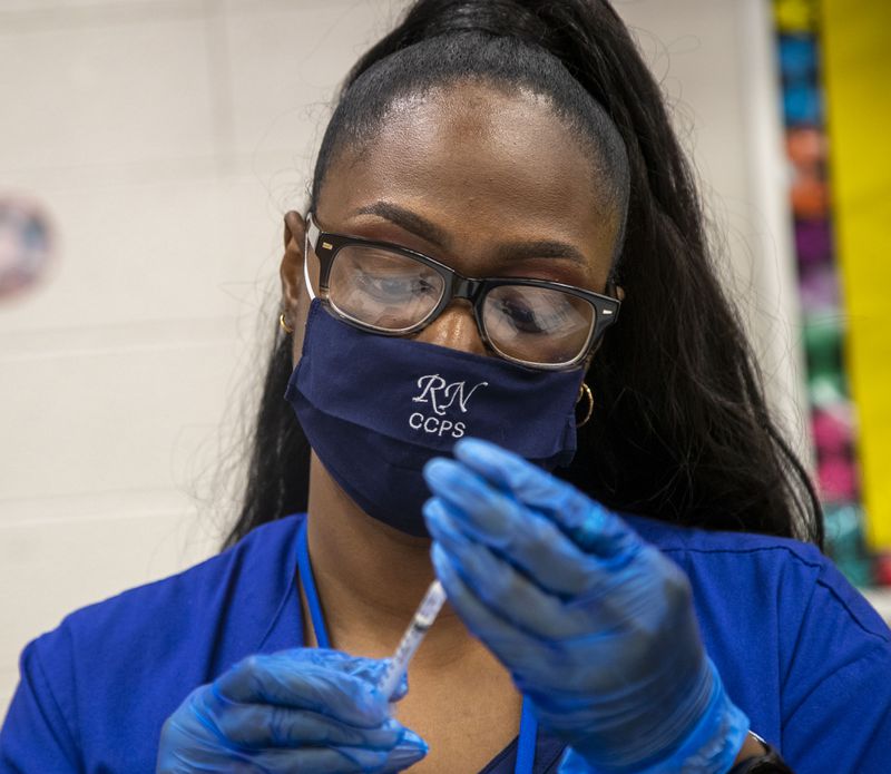 Clayton County Public Schools Nurse Supervisor Cynthia Pittman works a Clayton County Public Schools COVID-19 vaccination and testing drive at G.P. Babb Middle School in Forest Park in September. (Alyssa Pointer/Atlanta Journal Constitution)
