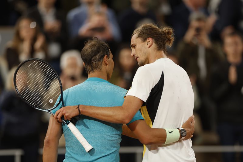 Germany's Alexander Zverev, right, speaks with Spain's Rafael Nadal after winning the game during their first round match of the French Open tennis tournament at the Roland Garros stadium in Paris, Monday, May 27, 2024. (AP Photo/Jean-Francois Badias)