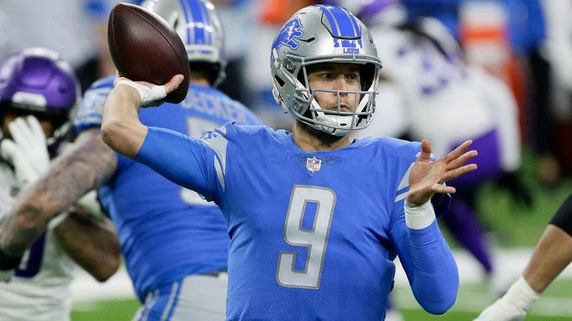 Georgia quarterback Matthew Stafford holds up his Detroit Lions