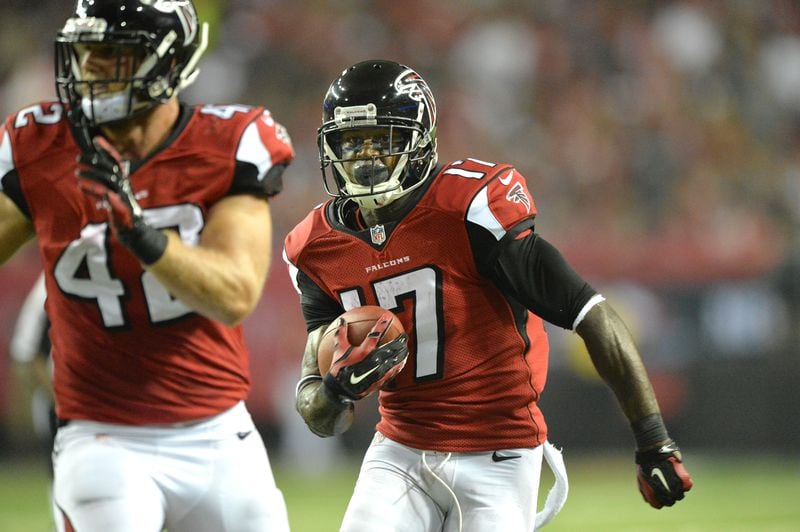 September 18, 2014 Atlanta - Atlanta Falcons wide receiver Devin Hester (17) runs for a touchdown against the Tampa Bay Buccaneers as Atlanta Falcons fullback Patrick DiMarco (42) clears his way in the first half during the first half in their NFL football game on Thursday, September 18, 2014. HYOSUB SHIN / HSHIN@AJC.COM