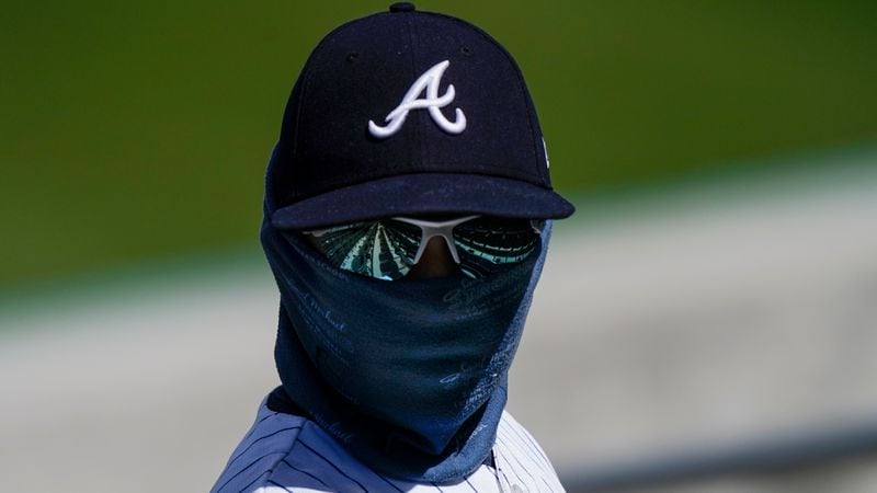 An Atlanta Braves fan looks for his seat before a spring training game March 1, 2021, against the Boston Red Sox in Fort Myers, Fla. Fans at Atlanta's Truist Park will have to adhere to mask rules and social distancing during the 2021 season. (Brynn Anderson/AP)