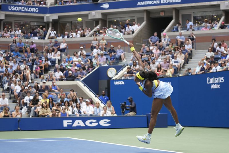 Coco Gauff, of the United States, serves to Emma Navarro, of the United States, during the fourth round of the U.S. Open tennis championships, Sunday, Sept. 1, in New York. 2024. (AP Photo/Pamela Smith)