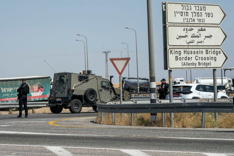 Israeli police stand guard near the site of a deadly shooting attack where Israeli officials say three people were shot and killed at the Allenby Bridge Crossing between the West Bank and Jordan, Sunday, Sept. 8, 2024. (AP Photo/Mahmoud Illean)