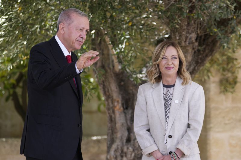 Turkey's President Recep Tayyip Erdogan, left, is welcomed by Italian Prime Minister Giorgia Meloni at the G7 in Borgo Egnazia, near Bari in southern Italy, Friday, June 14, 2024. (AP Photo/Luca Bruno)