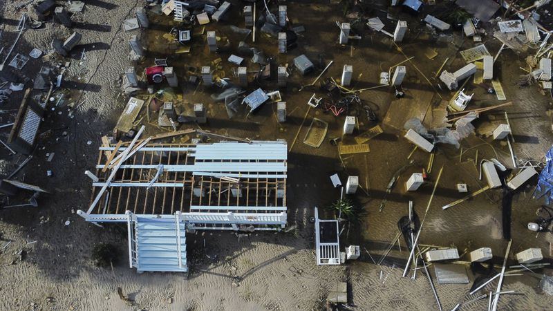 Foundations and steps to buildings that were destroyed by the storm surge from Hurricane Helene are seen along the shoreline in the aftermath of the storm, in Cedar Key, Fla., Friday, Sept. 27, 2024. (AP Photo/Stephen Smith)