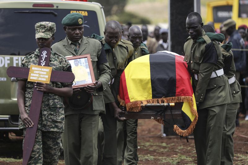 Members of the Uganda People's Defense Force carry the casket of Ugandan Olympic athlete Rebecca Cheptegei ahead of her burial in Kapkoros, Bukwo District, Uganda, Saturday, Sept. 14. 2024. (AP Photo/Hajarah Nalwadda)