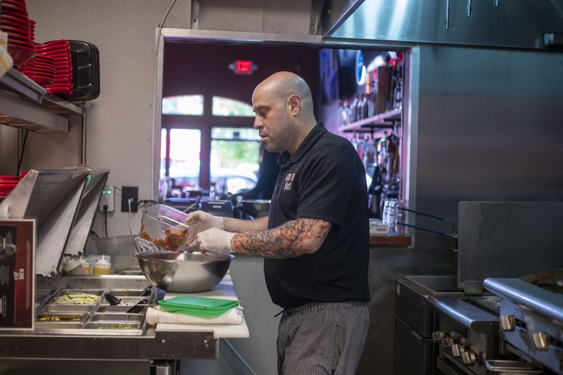 Cantina Loca head chef Dustin Brand works in the kitchen of the restaurant in Alpharetta, Monday, May 17, 2021. (Alyssa Pointer / Alyssa.Pointer@ajc.com)