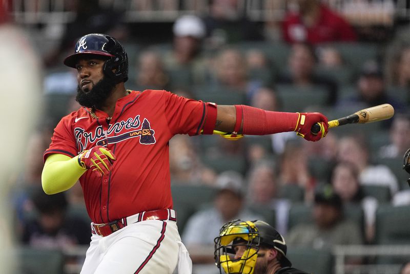 Atlanta Braves designated hitter Marcell Ozuna follows through on a three-run double in the third inning of a baseball game against the Pittsburgh Pirates Friday, June 28, 2024, in Atlanta. (AP Photo/John Bazemore)