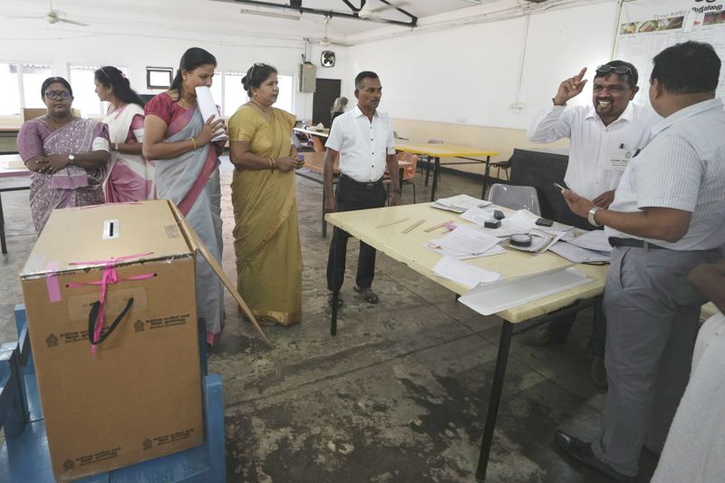 Polling officers set up their booth in Colombo, Sri Lanka, Saturday, Sept. 21, 2024. (AP Photo/Rajesh Kumar Singh)