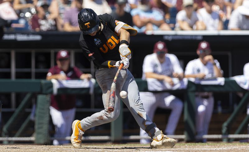 Tennessee's Cal Stark hits a ground ball that was turned into a double play against Texas A&M in the sixth inning of Game 2 of the NCAA College World Series baseball finals in Omaha, Neb., Sunday, June 23, 2024. (AP Photo/Rebecca S. Gratz)